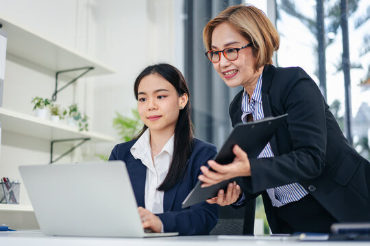 Business Women Collaborating on Laptop in Office Discussing Stra