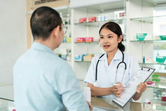 A woman in a white uniform is talking to a man in a white shirt
