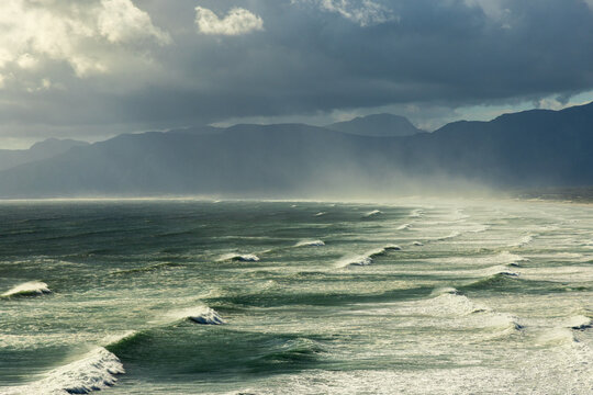 aerial view of massive wave sets rolling into Walker Bay Nature Reserve, South Africa 