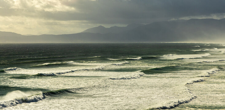 aerial view of massive wave sets rolling into Walker Bay Nature Reserve, South Africa 