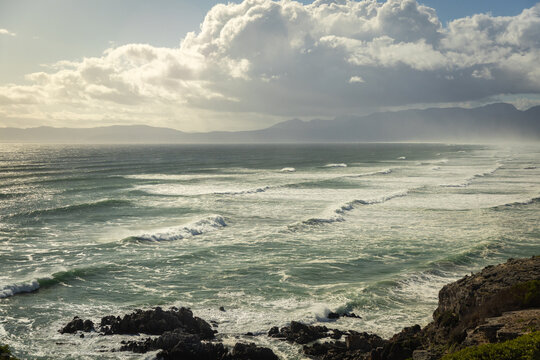 aerial view of massive wave sets rolling into Walker Bay Nature Reserve, South Africa 
