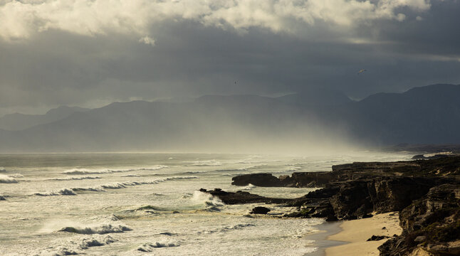 elevated view of massive wave sets crashing into rock formations, Walker Bay Nature Reserve, South Africa 