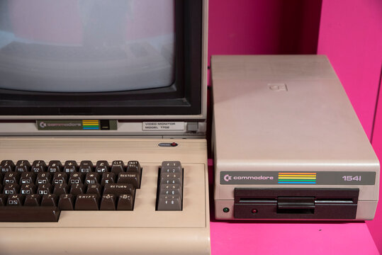 Commodore was an American computer company (1955&ndash;1994) founded in West Chester, Pennsylvania by businessman Jack Tramiel. Pink background.