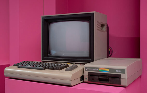 Commodore was an American computer company (1955&ndash;1994) founded in West Chester, Pennsylvania by businessman Jack Tramiel. Pink background.
