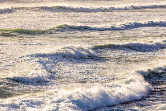 massive waves crashing into rock formations, Walker Bay Nature Reserve, South Africa at sunset