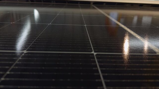 Solar Panel Surface Reflects Interior Light, Showing Clean Renewable Energy Technology and Sustainable Power Generation