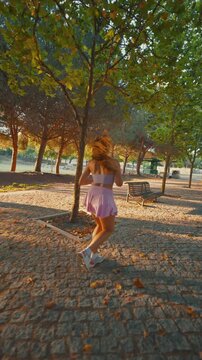 Young active woman jogging in a park during sunset