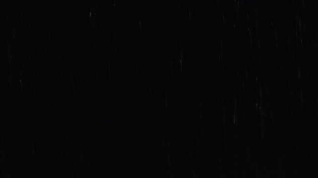 Falling Raindrops Create Fine Vertical Streaks Across a Black Background, Abstract Weather Texture With Moody Atmospheric Detail