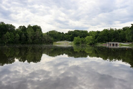 The peaceful lake in the park on a cloudy day.