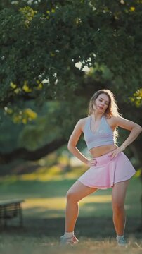 Dance performance in a park during evening hours with a focus on movement and style