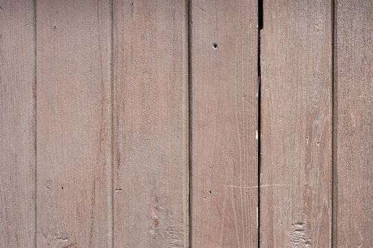 Weathered brown wood planks background featuring rustic texture for professional graphic design