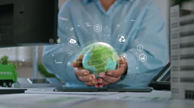 Businesswoman holding a green globe, ESG concept (Environmental, Social, and Governance), reviewing ESG reports and green financial charts, sustainability, love the earth, and eco-friendly.