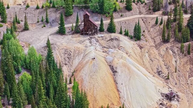 Closeup aerial view reveals weathered timber headframe of historic Yankee Girl Mine near Ironton along Million Dollar Highway Colorado