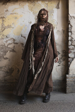 Mysterious wanderer in long hooded linen cloak, face hidden by hair, post-apocalyptic fantasy look
