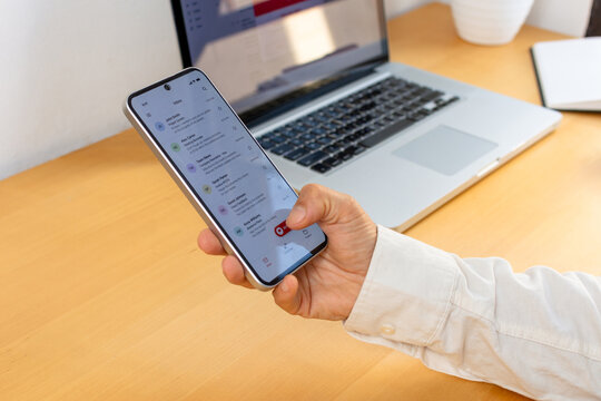 Smartphone user checking email before reporting suspicious message