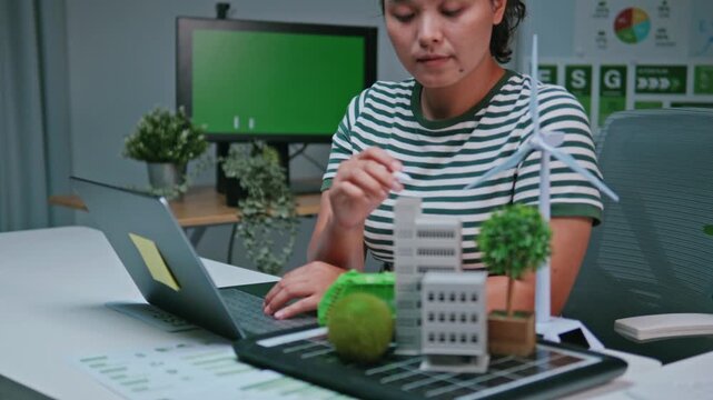 A female engineer analyzing and modeling a modern building, focusing on eco-friendly architecture, sustainable green business with renewable energy, future goals, and environmental sustainability.