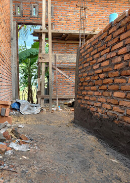 Unfinished Brick House Interior with Wooden Construction Framework