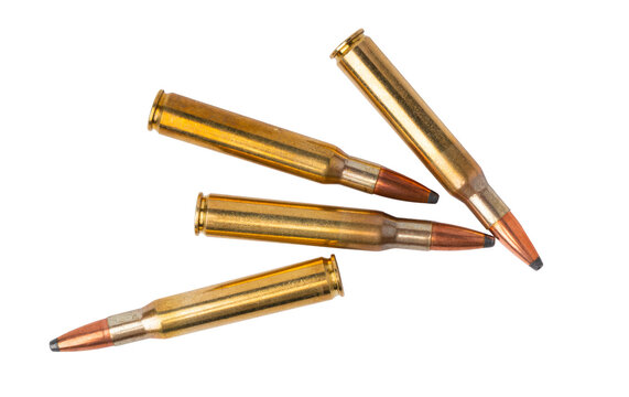 Several bullets lying on a white surface in a random arrangement