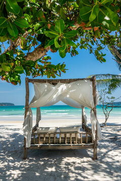 Canopy bed on the beach, resort at Saracen Bay on the island of Koh Rong Sanloem, Cambodia