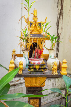 Golden traditional Spirit house, small shrine incense and statues in Cambodia, Southeast Asia