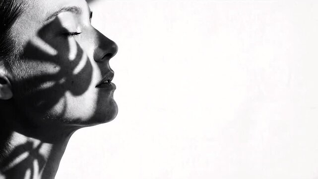 Profile Silhouette of Woman with Moving Leaf Shadows on Face