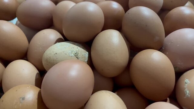 Close up of raw brown chicken eggs stack texture