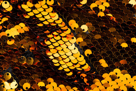 Golden sequins fabric creating sparkling texture pattern background
