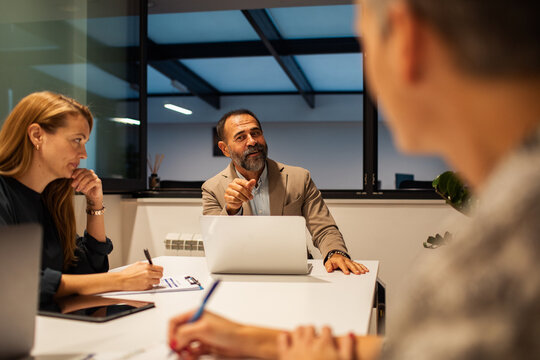 Manager leading team discussion in office meeting