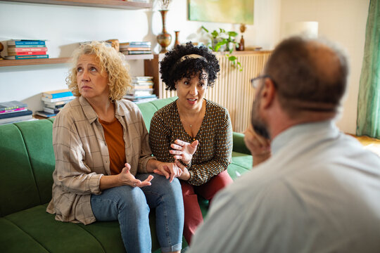 Two women talk with counselor during home session