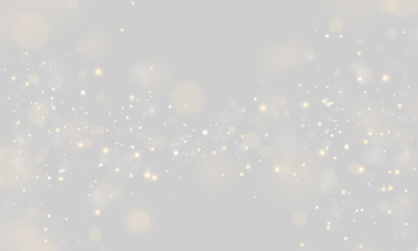 Golden and white bokeh particles scattered across a dark background create a shimmering effect. The lights vary in size and intensity, softly glowing with a warm ambiance.