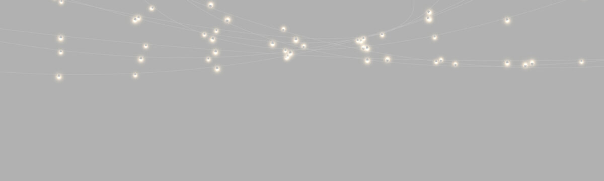 A cluster of small hanging lights with a warm yellow glow illuminates softly against a pitch-black background. The lights are connected with thin, barely visible wires forming a network.