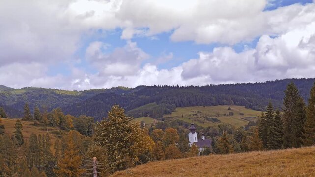 Autumn Pieniny mountain range Landscape With Hilltop Church, Forested Mountains and Cloudy Blue Sky, Pieniny, Poland