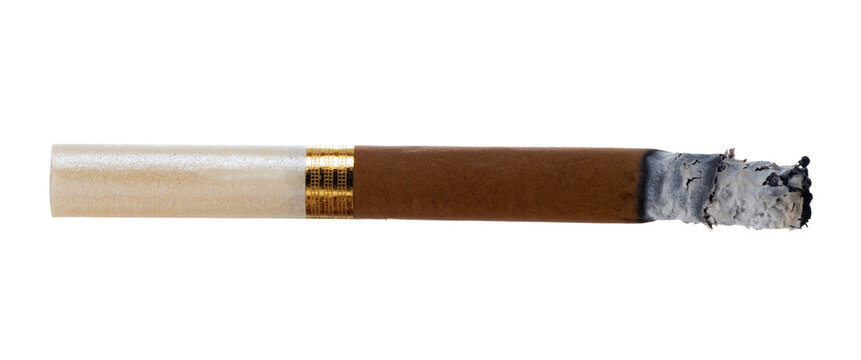 Cigarette rests on a flat surface with smoke fading away after use