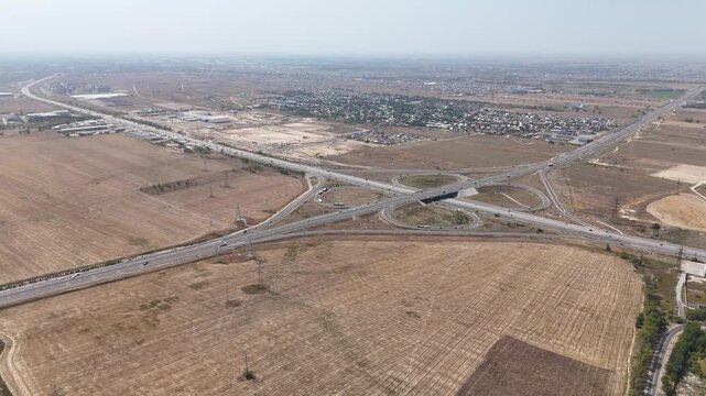 Drone Aerial of Cloverleaf Highway Interchange Through Dry Farmland