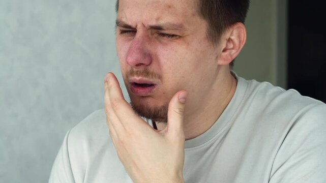 The man is bothered by a cough.
Sore throat due to tonsillitis.