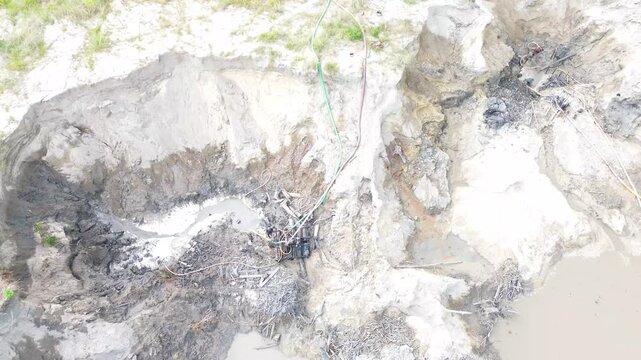 Local Miner Operating Diesel Engine for Traditional Tin Mining