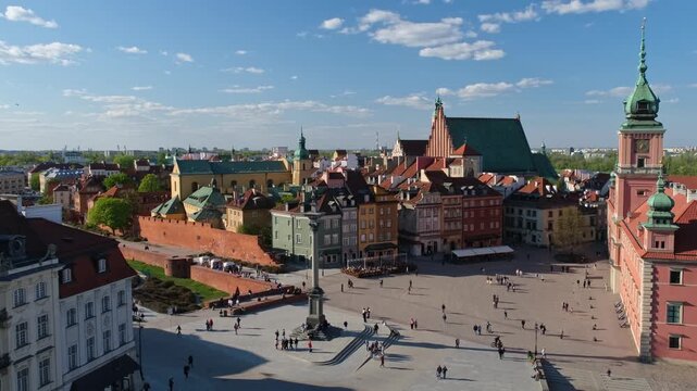 Elevated view of Castle Square in Warsaw Old Town with the Royal Castle, Sigismunds Column, St Johns Archcathedral, historic facades, and pedestrians