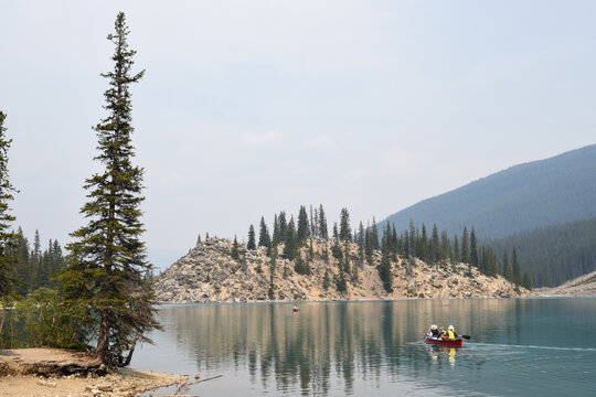 Tourists using the canoe at lake Moraine on Banff national park in Canada
