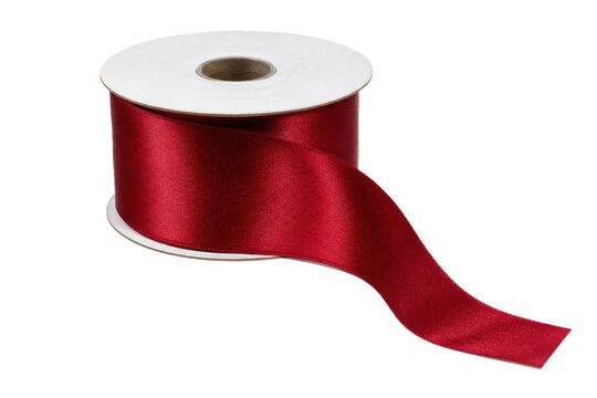 Vibrant red satin ribbon spool with a shimmering texture, partially unrolled and isolated on a clean white background