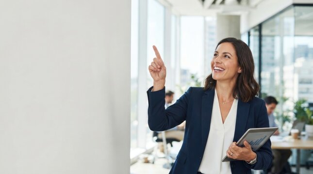 Successful businesswoman smiling with tablet in modern office