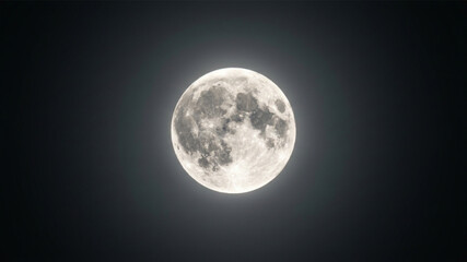 Bright full moon illuminating dark night sky. © Design and Icon