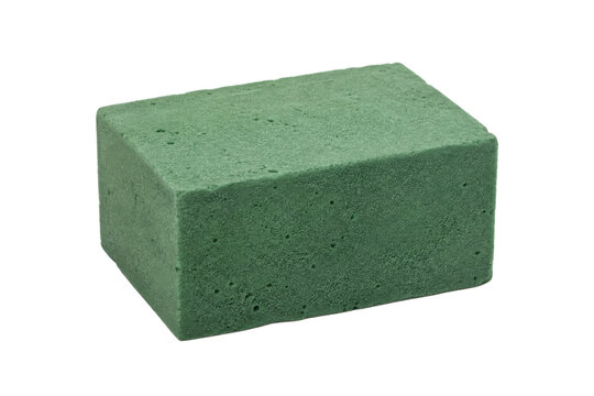 Single rectangular block of green floral foam with a porous texture is isolated on a clean white background