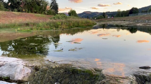 River flow over rocky threshold with sunset reflections in Lower Austria