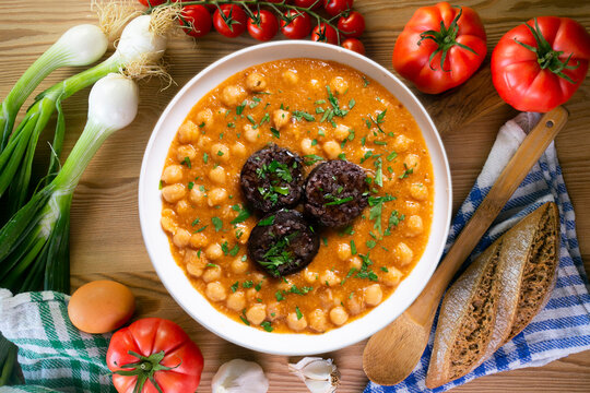 Spanish chickpea tapa in tomato sauce with black rice sausage. A festive dish for Christmas.
