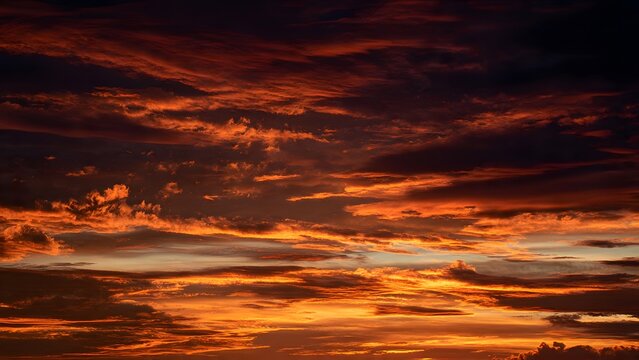 Intense burning sunset sky with deep crimson and orange clouds creating dramatic atmospheric landscape perfect for high quality visual projects requiring powerful emotional and nature inspired themes.