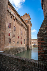 Obraz premium Walls and tower of Castello Estense in Ferrara framed by a brick parapet