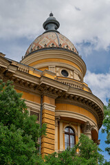 Rotunda and tiled dome of the Eotvos Lorand University Library seen through surrounding trees in Budapest © Guillaume Angleraud
