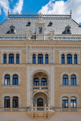 Arched windows and carved stone ornament on the upper storeys of Drechsler Palace facade in central Budapest © Guillaume Angleraud