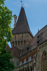 Weathervane topped spire above a corbelled romanesque tower and gothic gables at Vajdahunyad Castle Budapest © Guillaume Angleraud