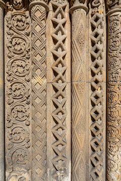 Close up of carved romanesque columns with interlace and floral patterns at the Jaki Chapel portal Budapest